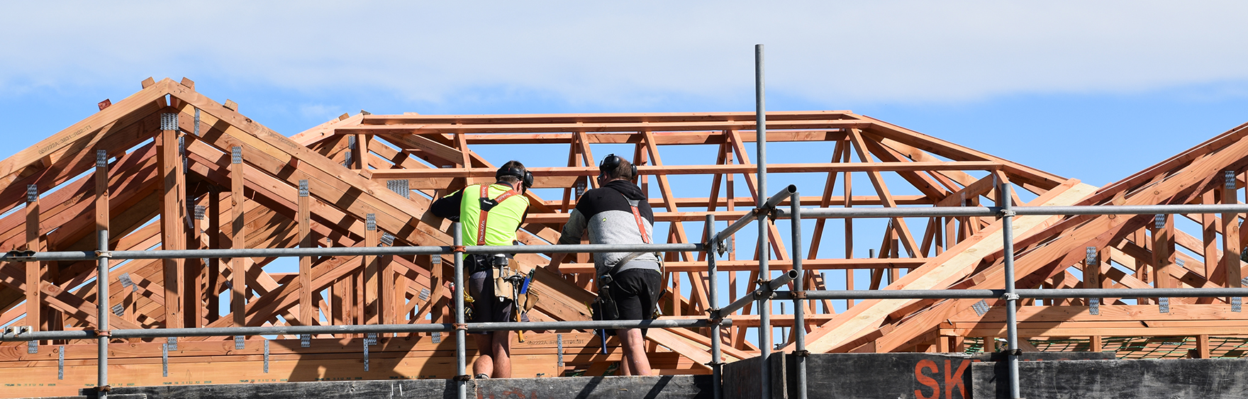 Image of two builders working on the roof truss of a home under construction in Silverstream subdivision.